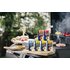 The photo shows various barbecue spices on a grill. In the photo you can also see meat, vegetables and garlic.